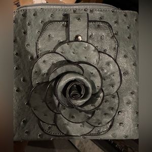 Very Cute Crossbody Bag. Big flower on front. Snap opens on flower to hold phone